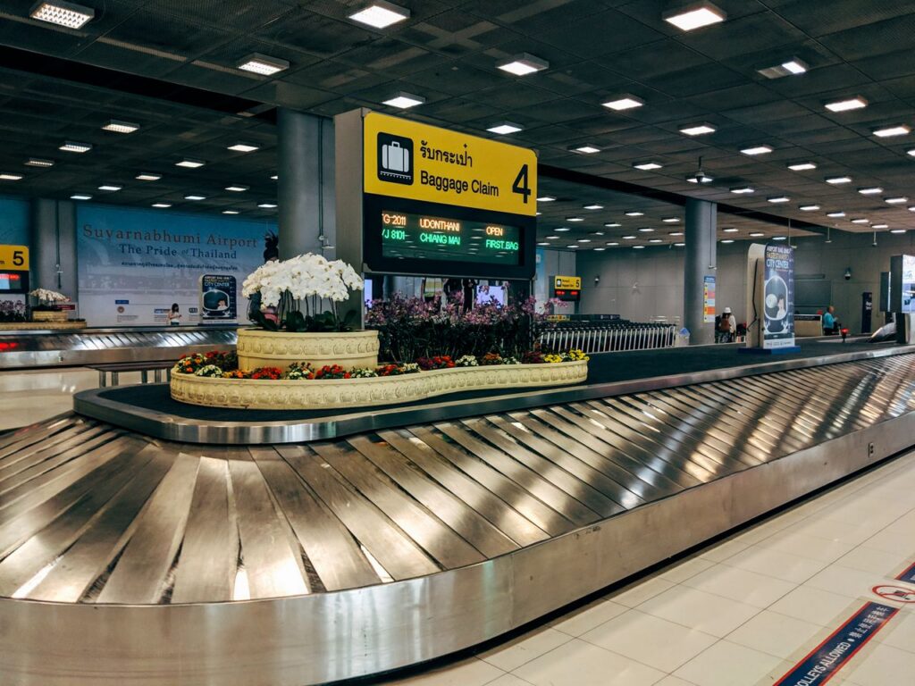 pexels photo 3693017 Modern baggage claim area at Suvarnabhumi Airport in Bangkok with luggage carousel and signage.